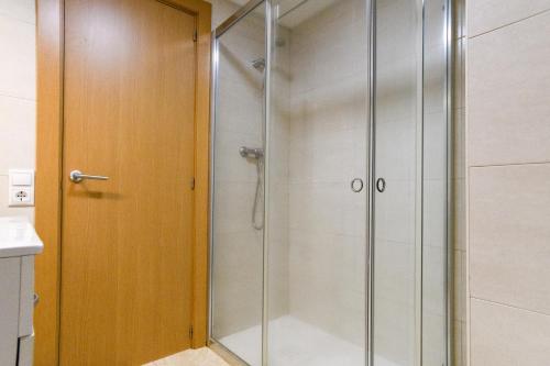 a shower with a glass door in a bathroom at Rentalmar Mas d'en Gran in Cambrils
