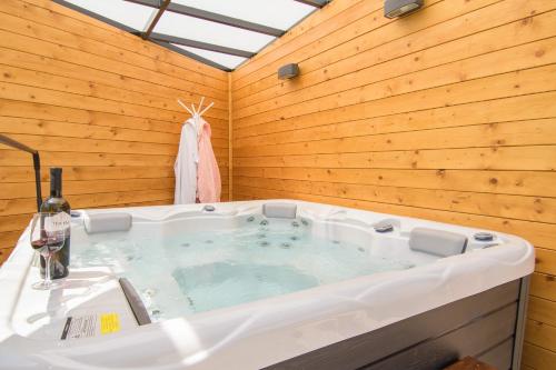 a jacuzzi tub in a room with a wooden wall at Holiday Home Giovanni Vabriga with private Jacuzzi in Vabriga