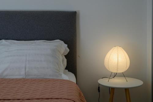 a lamp on a table next to a bed at 5 meters from the beach in Chrani