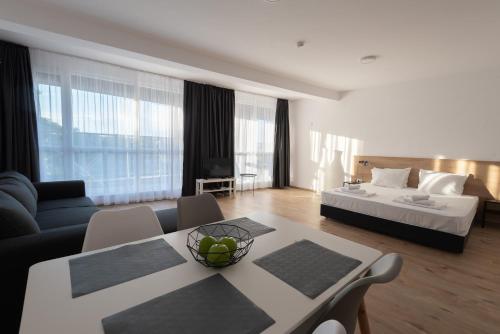 a hotel room with a bed and a table and chairs at Aparthotel Primorsko in Primorsko