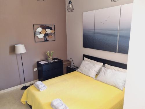 a bedroom with a bed with a yellow bedspread at Studio apartment Gemelli in Poreč