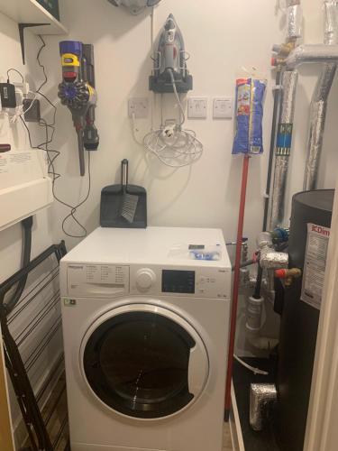 a laundry room with a washing machine in it at The Retreat in Weston-super-Mare