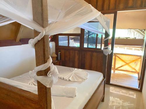 a bedroom with a bunk bed with a canopy at Utulivu Bungalow in Nungwi