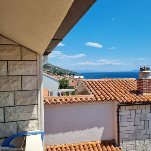a view of the ocean from the balcony of a house at Villa Mila in Bol