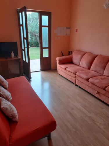 a living room with a red couch and a door at apartman VRIS Makarska-family apartment in Makarska