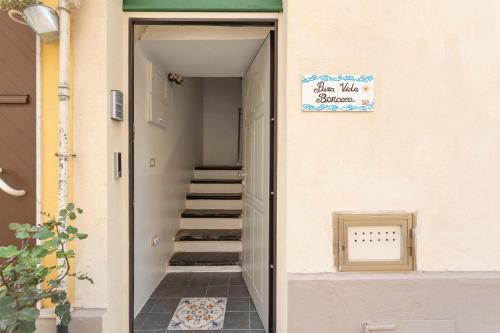 a hallway of a building with a stairway with a sign at Pura Vida Barocca in Ragusa
