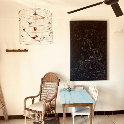 a dining room with a table and chairs and a ceiling fan at Hôtel Lido Beach in Hyères