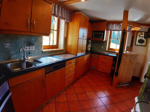 a kitchen with wooden cabinets and a sink at Lachtalhütte in Lachtal