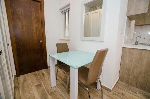 a small table and chairs in a small kitchen at Valletta Republic Suite in Valletta
