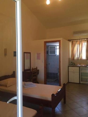 a living room with a bed and a kitchen at Pounta Apartments in Vingláfia