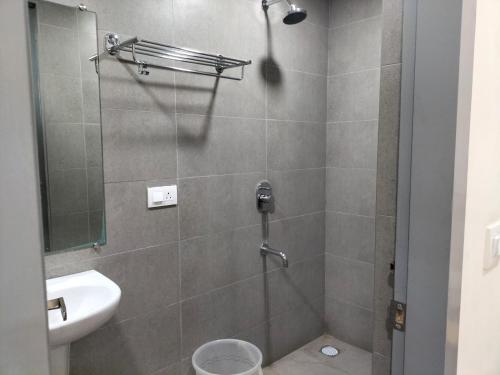 a bathroom with a shower with a toilet and a sink at GRACE RESIDENCY in Chennai