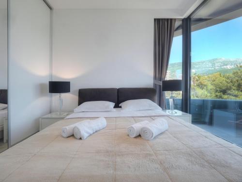 a bedroom with a large bed with two towels on it at Royal Montesun Apartments in Budva