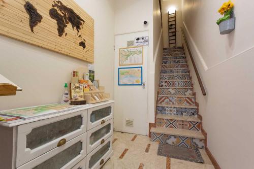 a hallway with a staircase and a room with a dresser at Pura Vida Barocca in Ragusa