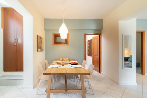 a dining room with a table and chairs at Menta Casa in Karteros