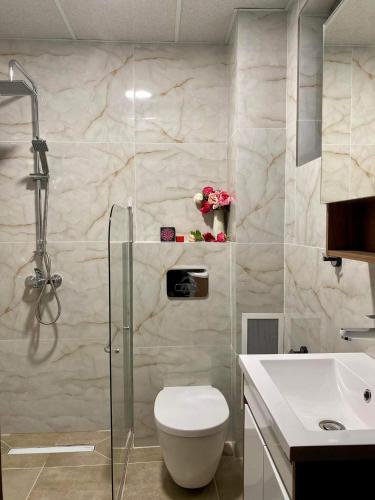 a bathroom with a shower and a toilet and a sink at Sozopol Dreams apartman 35 in Sozopol