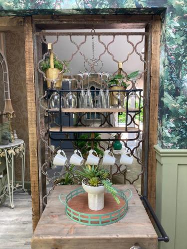 a shelf with pots and a potted plant on a table at Ballybur Lodge Mews 1 in Kilkenny