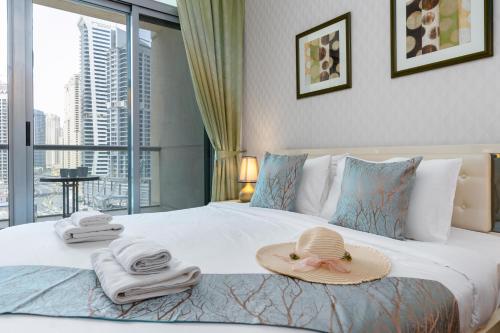 a hotel room with a bed with a hat on it at Vacay Lettings - 1 Bed at Iris Blue, Dubai Marina in Dubai