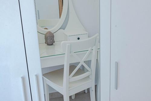 a white desk with a chair and a mirror at Suartini Apartmani Račišće in Račišće