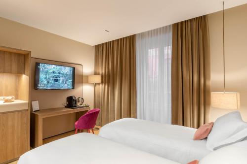 Кровать или кровати в номере PALAZZO UBERTINI Urban Suites