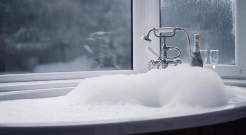 a bathroom sink with snow on it with a window at The Coylet Inn by Loch Eck in Dunoon