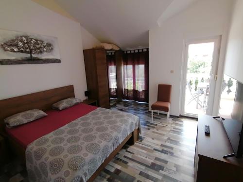 a bedroom with a bed and a large window at House Srima-Vodice Dalmatia in Srima