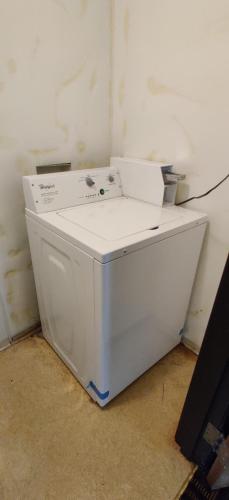 a white washing machine sitting in a room at Super 8 by Wyndham Champaign in Champaign