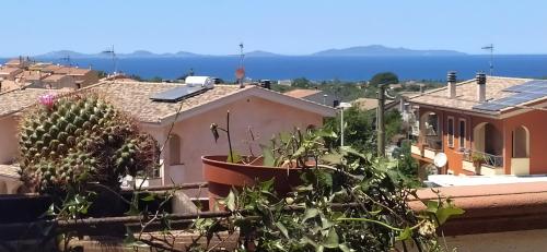 a view of a city from a balcony with plants at B&B Golfo Asinara Suite & Relax in Sorso