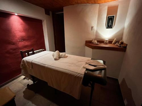a bedroom with a bed with towels on it at Chalet Suisse Posada & SPA - Adults only in Villa General Belgrano