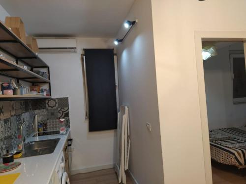 a kitchen with a sink and a refrigerator at Lovely 1 bedroom apartment near Eye of Tirana in Tirana