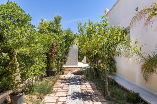 an alley with trees and a building at Panarea 22 in Calabernardo