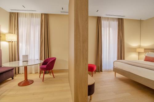 Кровать или кровати в номере PALAZZO UBERTINI Urban Suites