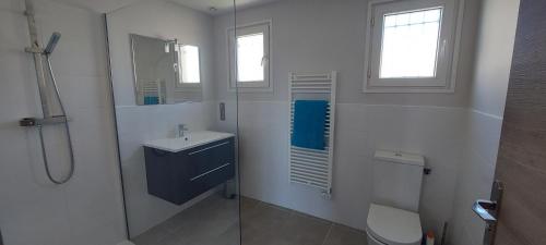 a bathroom with a toilet and a sink and a shower at Phare View in Marseillan