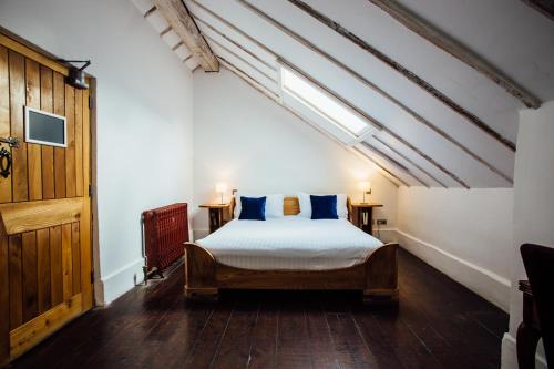 a bedroom with a bed with blue pillows at Bellinter House in Navan