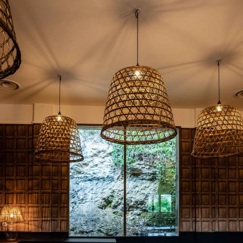 three lights hanging from a ceiling with a window at Hôtel Restaurant de Bouilhac in Montignac
