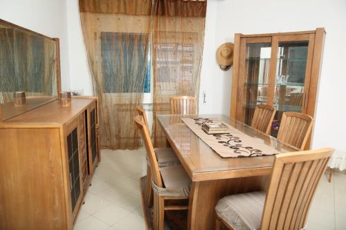 a kitchen with a wooden table and chairs at Villa Curubis Korba in Korba