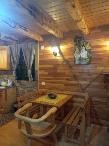 a wooden dining room with a table and chairs at Vila Darija in Žabljak