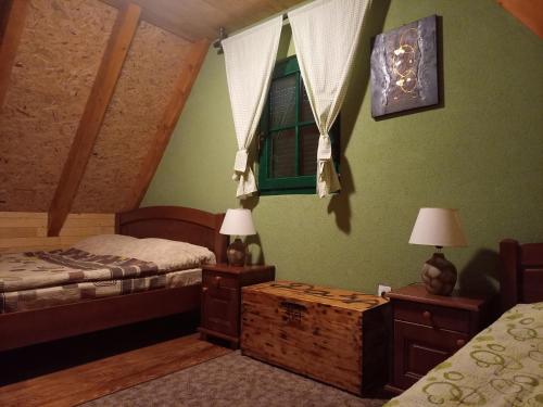 a bedroom with two beds and two tables with lamps at Vila Darija in Žabljak