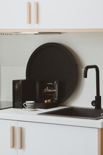 a microwave sitting on top of a kitchen counter at Essentia Vita Comfy Suites in Limenas