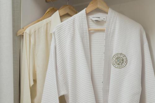 a white shirt is hanging on a rack at Essentia Vita Comfy Suites in Limenas