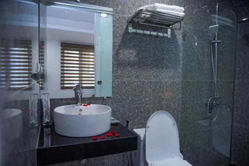 a bathroom with a sink and a toilet and a shower at B & B Hotel Quan Hoa in Hanoi