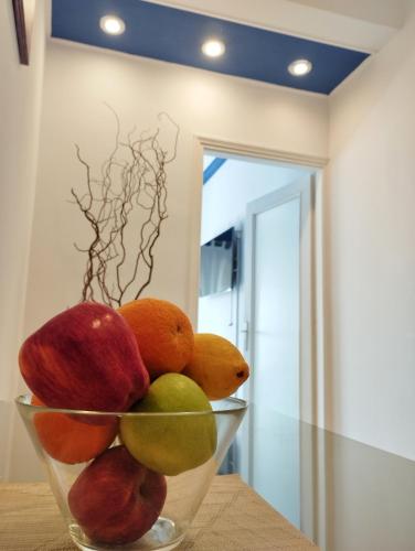 a bowl of fruit sitting on top of a table at CozyCoast in Rafina