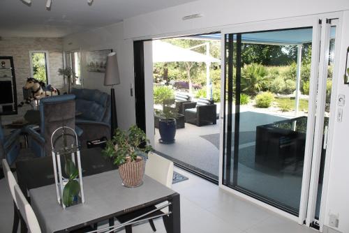 a living room with a sliding glass door at MOR-HA-MARCH Chambres d'Hôtes in Sarzeau