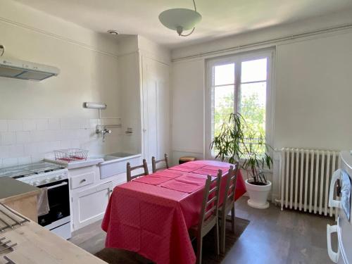 uma cozinha com uma mesa com uma toalha de mesa vermelha em GRAND F3 2 Ch CALME CONFORT PARKING RIVE GAUCHE CREPS HIPPODROME GOLF em Bellerive-sur-Allier