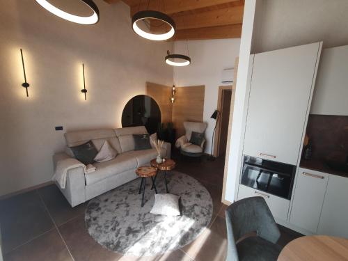 a living room with a couch and a table at Sibenbras Natural Aparthotel in Limone sul Garda