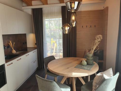 a dining room with a wooden table and chairs at Sibenbras Natural Aparthotel in Limone sul Garda