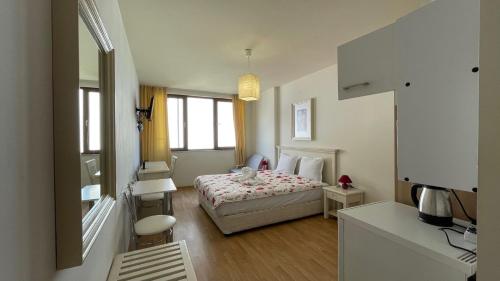 a hotel room with a bed and a desk and a room at SUN APARTMENTS 14 Studio Sunny Beach in Sunny Beach