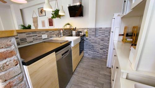 a kitchen with a sink and a counter at Holiday home Zora - family vacation house near protected area of the Nature Park Kamenjak, with green yard, WiFi, Air-con in Premantura