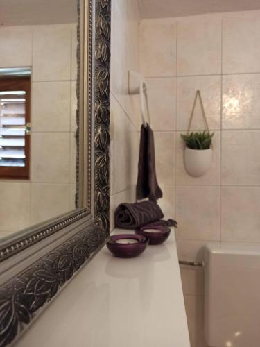a bathroom with a mirror and a sink and a tub at Guest House Mijo Sokol in Brela