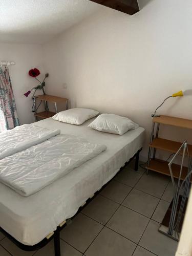 un lit avec deux oreillers dessus dans une chambre dans l'établissement petite Maison Cote D'Azur, à Cogolin
