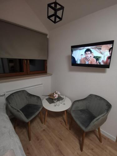 Televisyen dan/atau pusat hiburan di Apartament Luna
